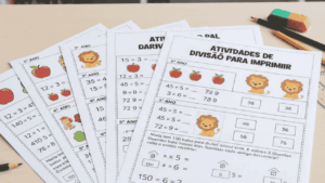 Folhas de atividades de divisão para imprimir, com exercícios matemáticos ilustrados para crianças do ensino fundamental, organizadas sobre mesa escolar com lápis, borracha e materiais educativos ao fundo.